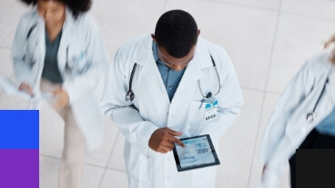 A doctor analyzing data on a tablet.